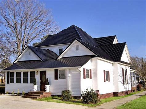 white and black metal house|contemporary homes with metal roofs.